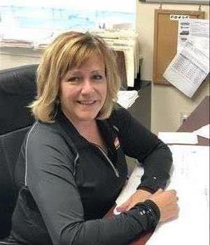 Lori sitting at her desk at the Overbrook office