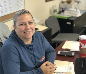 Tracy sitting at her desk at the Overbrook office